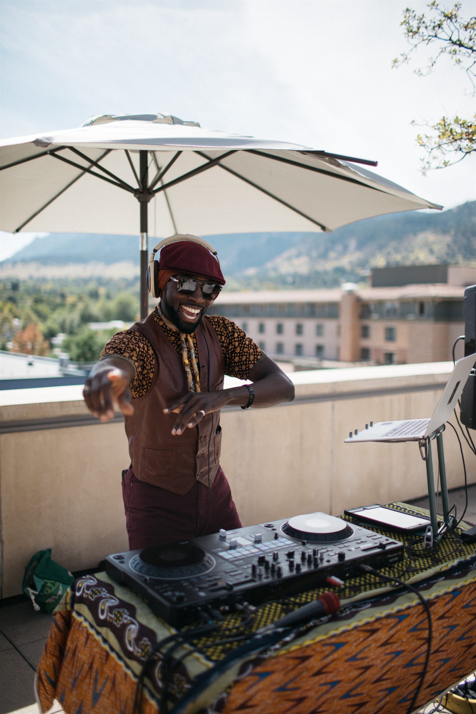 DJ Musa performing outside with Boulder views during last year's Boulder Skin Bar anniversary party.