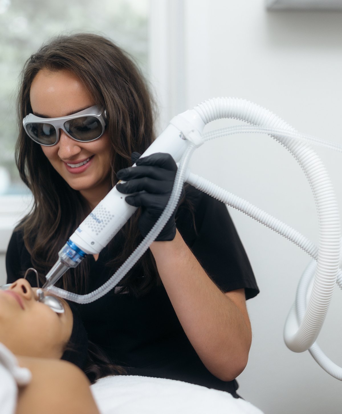 Esthetician performing a HydraFacial treatment on a client at Boulder Skin Bar