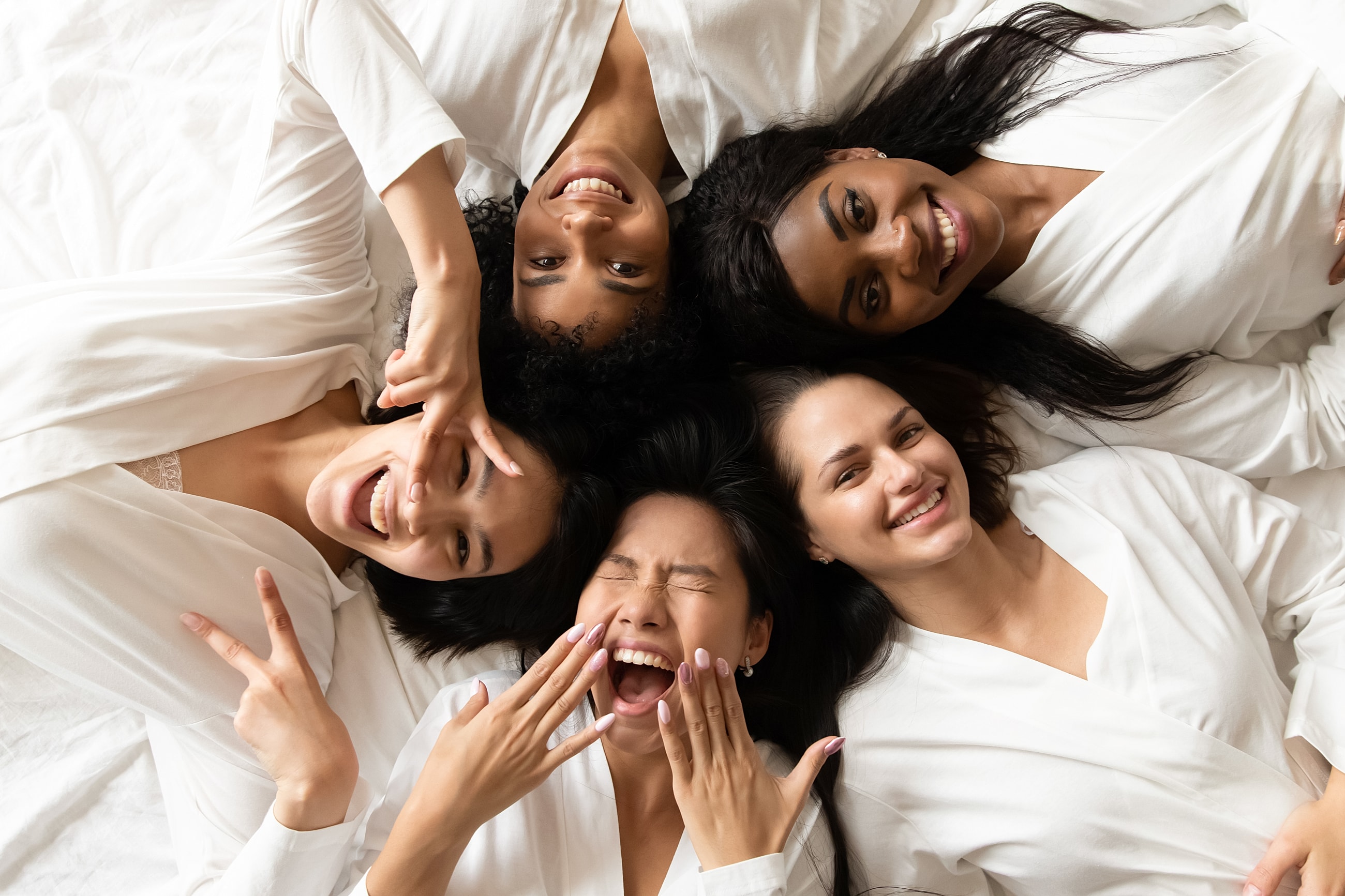 Friends enjoying a fun moment together in robes.