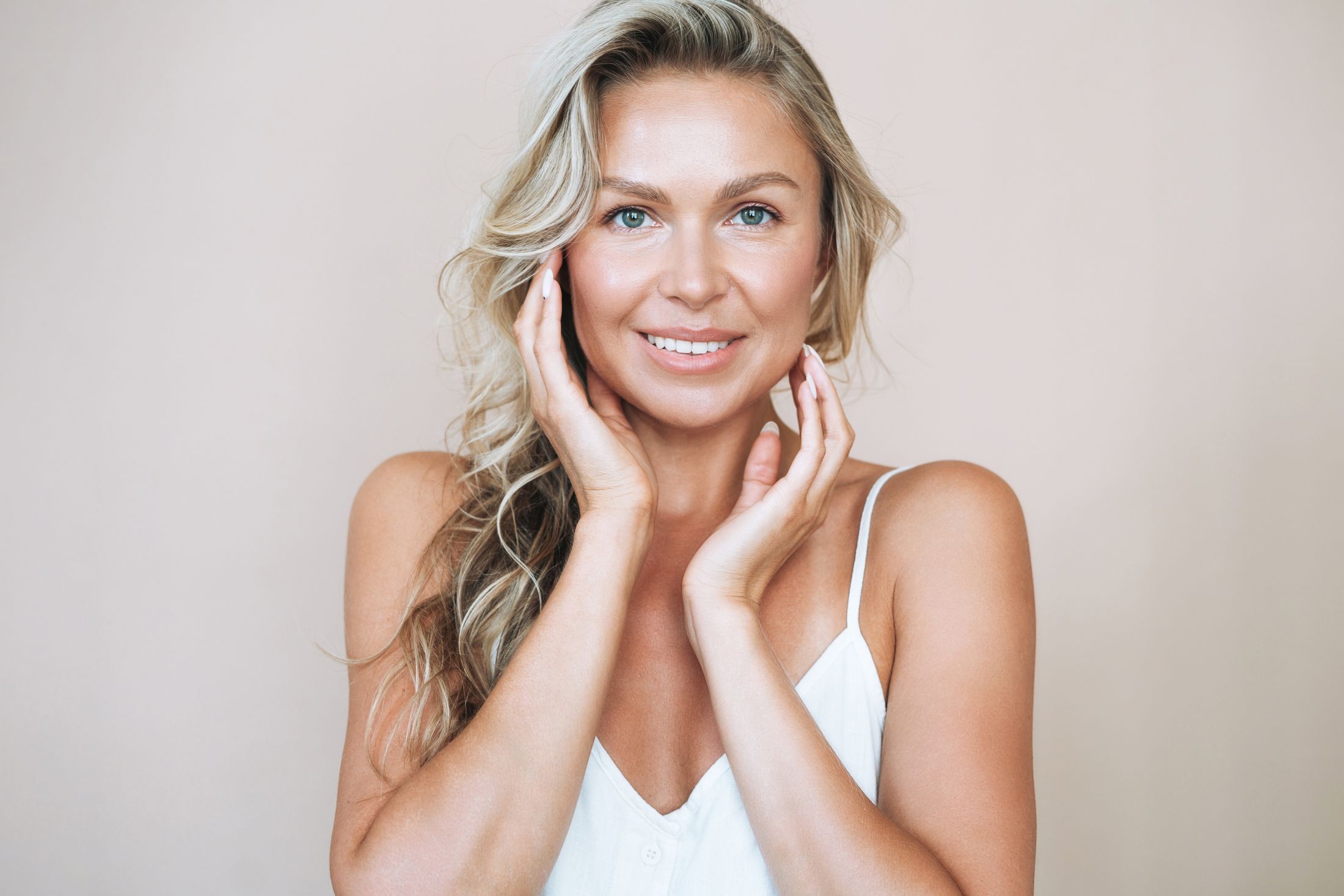 Woman resting her hands along her cheeks and jawline